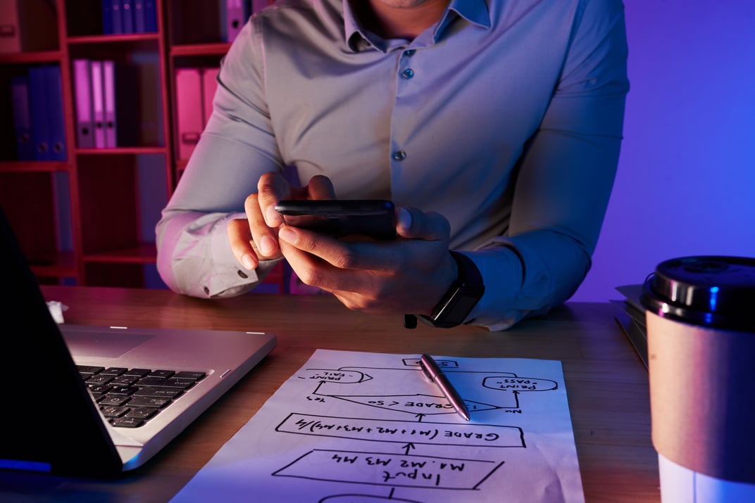 mid-section-unrecognizable-man-taking-picture-work-plan-phone